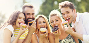 people eating donuts on a sunny day
